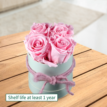 4 light pink roses in a hat box